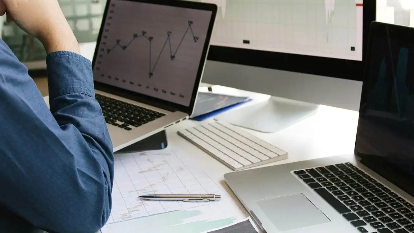 Investors are using laptops entering investment websites stocks market and partners